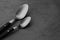 Clean empty table spoons on grey background, space for