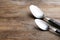 Clean empty table spoons on wooden background