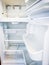 Clean empty white refrigerator with doors open