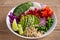 Clean healthy detox eating. Vegan and vegetarian lunch bowl. Quinoa, avocado, pomegranate, tomatoes, green peas, radish and red ca