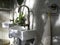 Clean loft style bathroom interior with white modern sink basin and brass faucet.