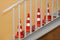 Clean new orange-white reflective road cones stand indoors