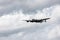 Clean photo of a Lancaster bomber starting it`s flypast with prop blur