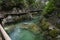 Clean river water goes through mountains, wooden bridges around. Slovenia, Vintgar gore near lake Bled