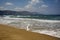 Clean sandy Georgioupolis beach, azure Mediterranean sea, mountains on the horison