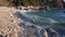 Clean sea water washes round pebbles at sunset