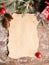 A clean sheet of paper of a branch of a spruce Christmas tree toys on dark wooden background. Festive Christmas concept.