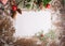 A clean sheet of paper of a branch of a spruce Christmas tree toys on dark wooden background. Festive Christmas concept.