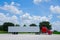 Clean shiny red semi tractor truck w cargo trailer