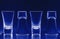 Clean shiny wine glasses in blue neon light in bar restaurant.