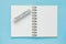 Clean spiral note book for notes and messages and september wooden calendar bar on blue background. Minimal business flat lay