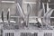 Clean spoons, forks and knives in a dishwasher basket, close-up