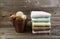 Clean stacked Towels and Bucket filled with Decorations on Weathered Wood