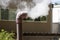 Clean steam form smoking small bronze pipe at hot springs