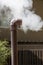 Clean steam form smoking small bronze pipe at hot springs