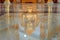 clean temple floor reflecting the image of a serene buddha statue