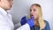 Clean tongue. The doctor teaches the patient how to clean the tongue properly. Dentist consultation. The blonde girl is trained in