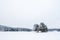 Clean view of a frozen lake with a small island with trees. Sognsvann lake in Oslo