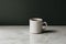 Clean white coffee mug on marble countertop, minimalist composition