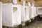 Clean white urinals in men`s bathroom
