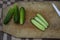 Cleaned green cucumbers on wooden tray cut into slices ready for preservation, tasty and healthy lifestyle ingredient for cook