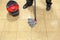 Cleaner with a mop and bucket cleaning a tiled floor