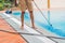 Cleaner of the swimming pool . Man in a blue shirt with cleaning