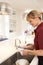 Cleaner Working In Domestic Kitchen