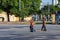 Cleaners men with brooms and shovels in the city square