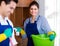 Cleaners in overalls with supplies