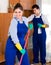 Cleaners in overalls with supplies