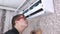 Cleaning the air conditioner from dust, mold and dirt. An air conditioner maintenance worker assesses the level of contamination,