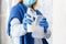 Cleaning by antibacterial alcohol spray. Woman Houseworker in rubber blue gloves clean by cloth rag, sanitize spray Surfaces. New