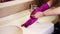 Before cleaning the bathroom, woman puts on her hands rubber protective gloves