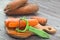 Cleaning carrots with a special vegetable peeler tool.