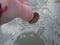 Cleaning a coin in water on White Island in New Zealand