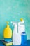 Cleaning concept with various plastic bottles and canisters on blue background.cleaning supplies including sponges.various