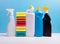 Cleaning concept with various plastic bottles canisters and sponges on blue background. Various detergents and the necessary