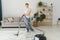 Cleaning concept. woman cleaning carpet with vacuum cleaner.