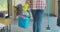 Cleaning concept. Woman with floor mop and bucket with washing fluids, back view.