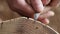 cleaning cracks on a wooden stump with a knife. peeling acacia bark. woodworking concept. wood texture