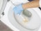 Cleaning a dirty home toilet with a brush and cleaning products