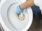 Cleaning a dirty home toilet with a brush and cleaning products. hand protection with gloves