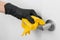 Cleaning door handle with yellow wipe in black gloves. Woman hand using towel for cleaning. Disinfection in hospital and