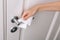 Cleaning door handles with an antiseptic wet wipe and gloves. Woman hand using towel for cleaning home room door link