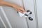 Cleaning door handles with an antiseptic wet wipe and gloves. Woman hand using towel for cleaning home room door link