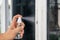 Cleaning door knob with alcohol spray for  Covid-19 Coronavirus prevention