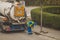 Cleaning drainage pipes of leaves and debris with a big vacuum tank truck. Unrecognisable worker cleaning water drains on the stre