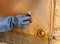 Cleaning gilded bronze of an antique door by hand