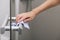 Cleaning glass door handles with an antiseptic wet wipe. Woman hand using towel for cleaning home room door link